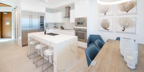 This image shows a modern and luxurious kitchen extending into a dining area