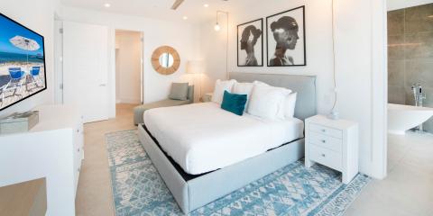 This image shows a modern, stylish bedroom with a coastal theme