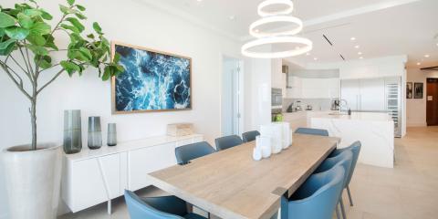 This image displays a modern dining room connected to an open kitchen