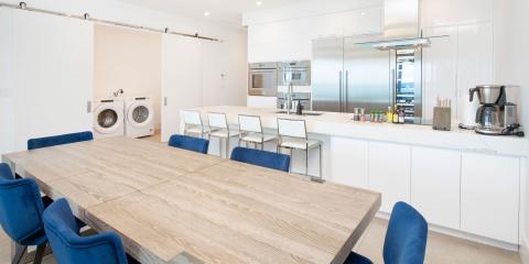 This image features a modern kitchen and dining area