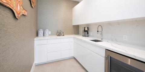 The image shows a modern kitchen interior, featuring a minimalist design with a predominantly white color scheme