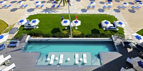 The image features an aerial view of a luxury outdoor resort area