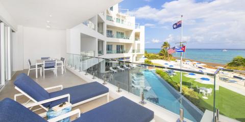 This image depicts a luxurious beachfront property, likely a hotel or resort