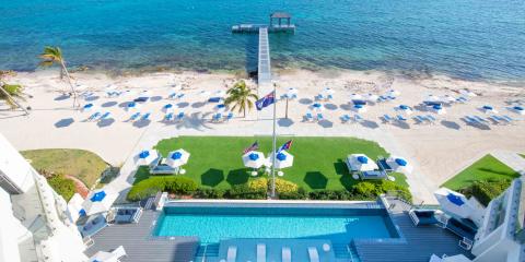 This image shows a luxurious beachfront scene, possibly at a hotel or resort