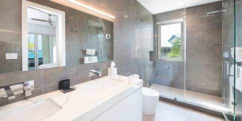The image shows a modern bathroom featuring a double vanity with two sinks, large mirrors, and ample counter space