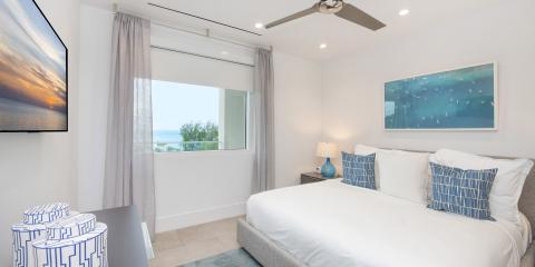 The image shows a modern bedroom with a coastal-inspired design