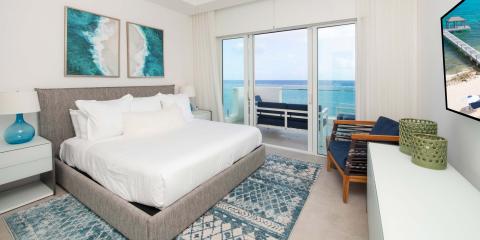 This image displays a modern and stylish beachfront bedroom