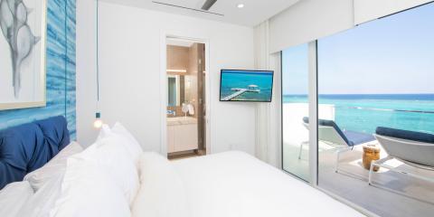 This image features a modern beachfront bedroom