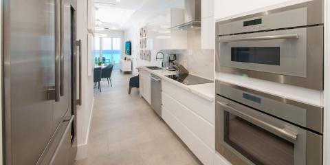 This image features a modern kitchen with a scenic ocean view