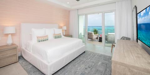 This image showcases a modern, beachside hotel room or vacation rental