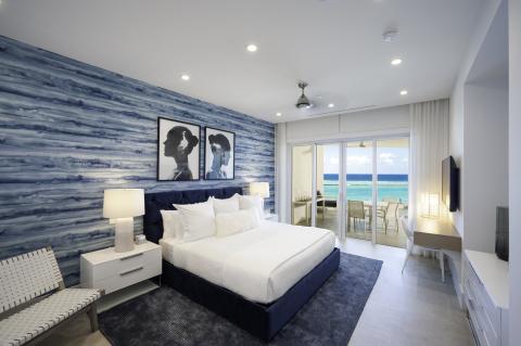 This image shows a modern and stylish bedroom with a coastal theme