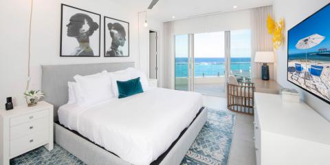 This image shows a modern beachfront bedroom