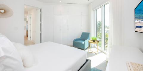 This image shows a modern, well-lit bedroom