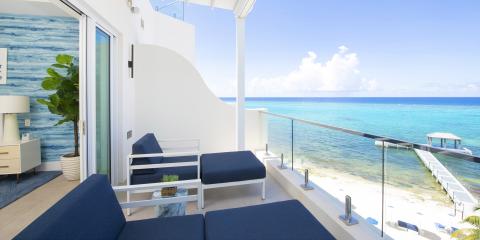 This image shows a luxurious beachside balcony or terrace of a modern home or resort