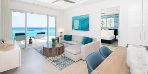 This image shows a modern beachfront living room opening up to a stunning ocean view