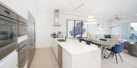This image shows a modern, luxurious open-plan kitchen and living room