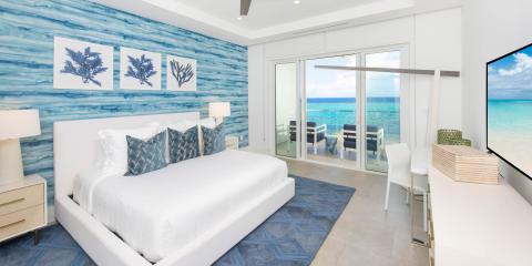 The image depicts a luxurious beachfront bedroom
