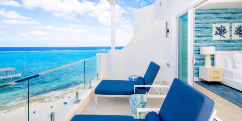 The image features a luxurious beachfront balcony attached to a bedroom