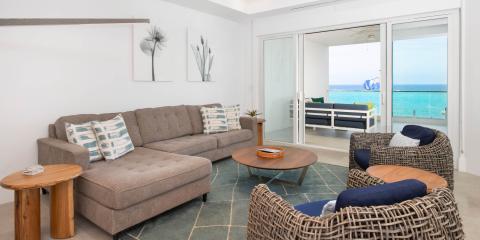 The image showcases a contemporary living room with a beautiful ocean view