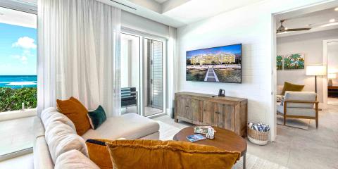 The image shows a bright and modern coastal living room
