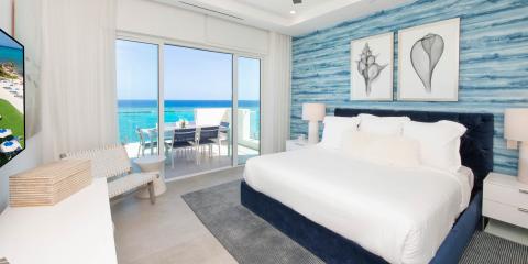 The image shows a luxurious seaside bedroom with an excellent ocean view