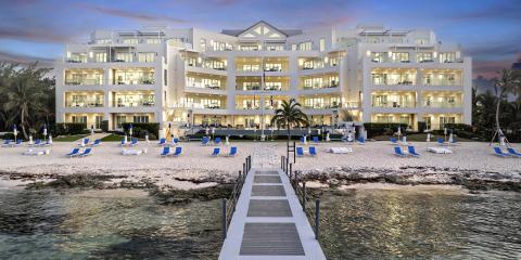 The image shows a modern, luxurious beachfront hotel or resort