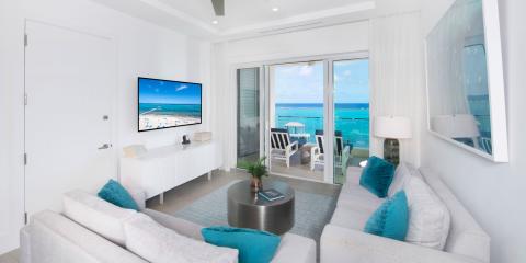 The image shows a modern, luxurious living room with a coastal design