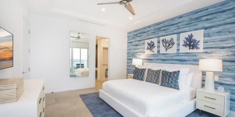 The image shows a modern, well-lit bedroom with a coastal interior design theme