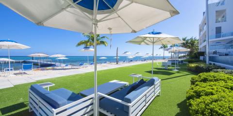 This image displays a luxurious beachfront outdoor relaxation area