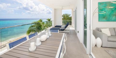 This image shows a balcony that overlooks a beautiful beach