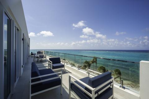 This image shows a beautiful balcony view of a beachfront setting