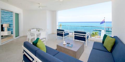 This image shows a beautifully decorated modern living space with a stunning ocean view