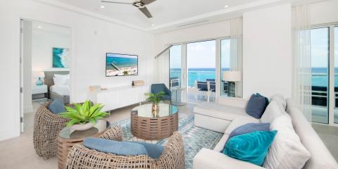 This image shows a modern and luxurious living space with a breathtaking ocean view