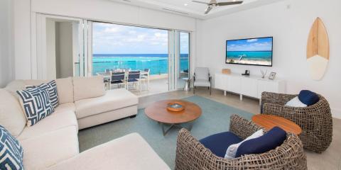 This image shows a modern and stylish living room with a fantastic ocean view