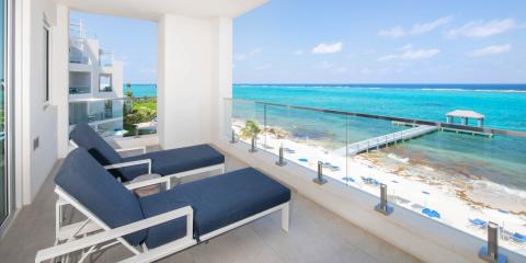 This image shows a scenic oceanfront view from a luxurious balcony