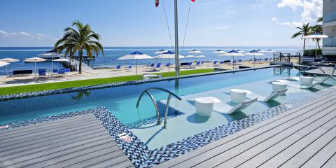 This image features a luxurious outdoor setting at a beachside resort