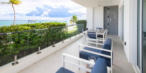 This image shows a balcony overlooking a beautiful beachfront view