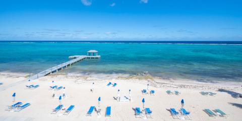 This image shows a beautiful beach scene with a clear blue sky