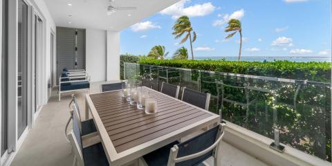 This image shows a modern balcony with a beautiful ocean view