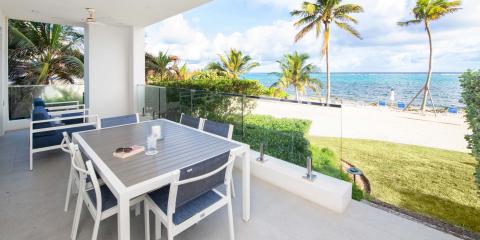 This image shows an outdoor patio setting looking out to a beach