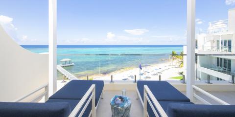 This image shows a beautiful beachfront view from a balcony