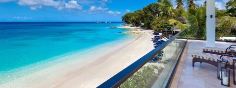 This image depicts a beautiful beachside view seamlessly connecting the serene environment of a tropical resort to a breathtaking beach