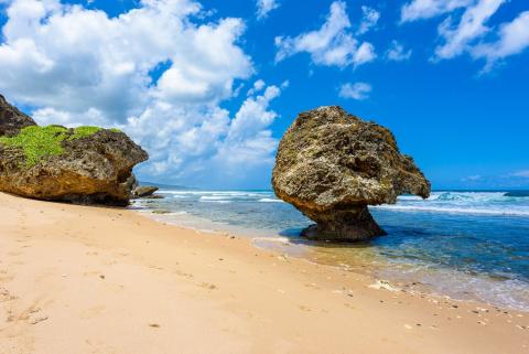 This image features a beautiful beach scene with distinctive geological formations