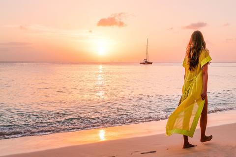 This image features a serene beach scene at sunset