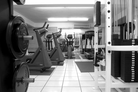 The image displays a well-equipped gym