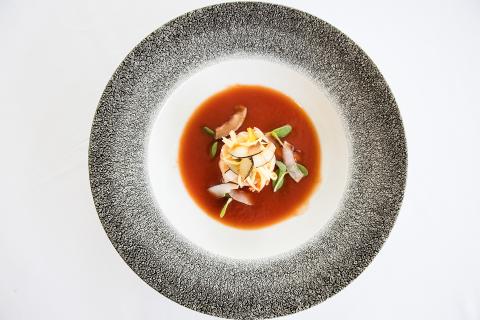 The image showcases a beautifully plated dish, served on a speckled grey platter