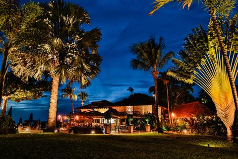 This image shows a beautifully lit tropical outdoor setting at dusk
