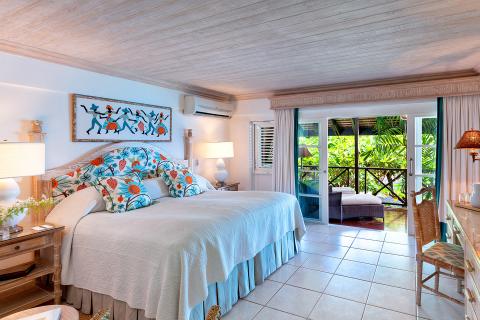 This image shows a well-appointed, tropical-style bedroom