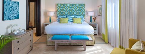 This image depicts a bright and refreshing bedroom decorated in a coastal style
