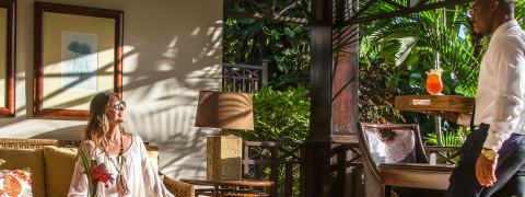 This image shows a scene set in a lush, tropical location, likely a resort or a deluxe sitting area